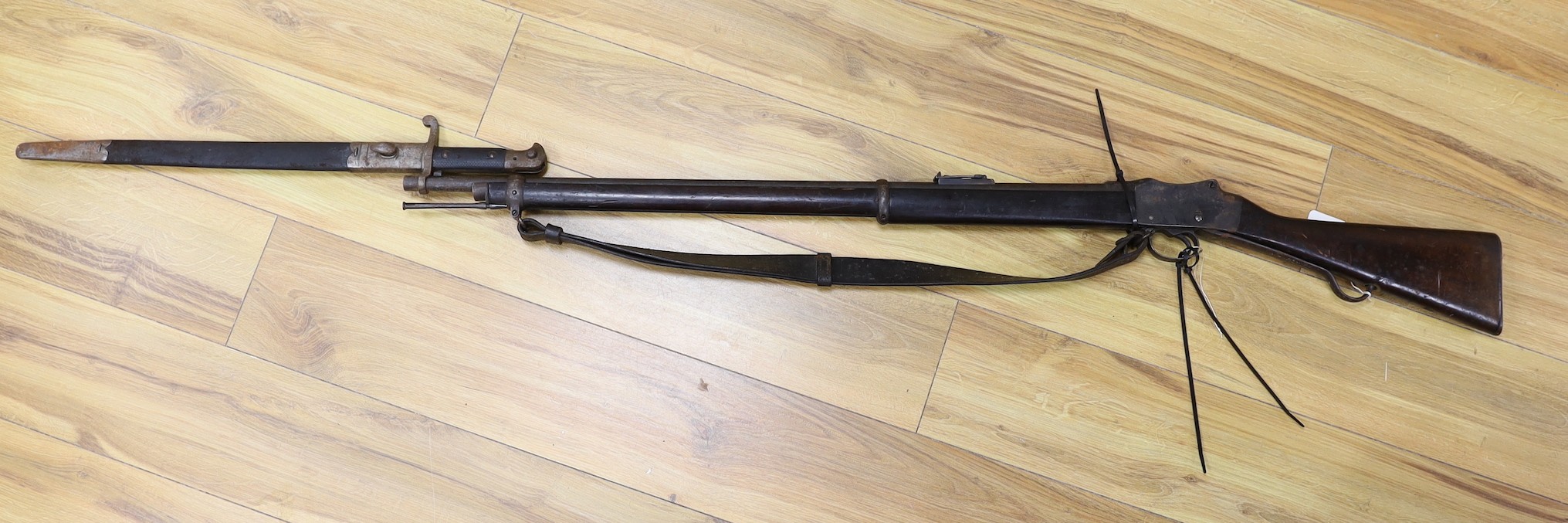 An Enfield breech loading .577 calibre rifle dated 1886, with Wilkinson bayonet and sheath
